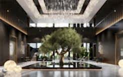 Expressive hall with a large orange tree. Jeff Koons sculptures adorn the space. A custom-made chandelier with thousands of crystals hangs from above. The wall finish is crafted from natural walnut with gradient staining