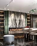 The bio fireplace is decorated with a variety of Cippolino striped marble and green velour.