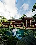 A series of outdoor pools and meditation areas unfold in front of the house