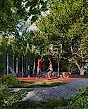 Basketball court with young people surrounded by greenery on a Studia 54 property