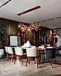 Dining table for guest gatherings. Chairs by Cattelan Italia, and a chandelier by Terzani