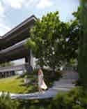 Contemporary landscape design with stairs and a woman in front of Studia 54 architecture