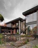 A combination of light wood, grey stone, panoramic glazing and warm outdoor landscape lighting